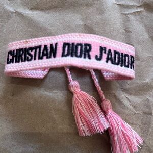 CHRISTIAN DIOR PINK COTTON SPELLOUT BRACELET , friendship series) tassels